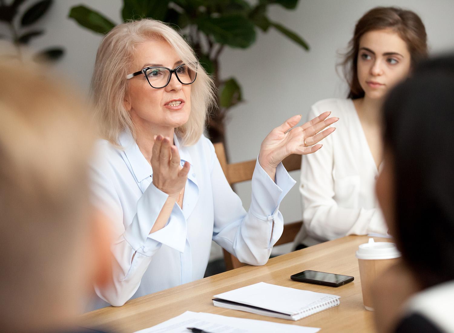 A leader having a meeting with her colleagues