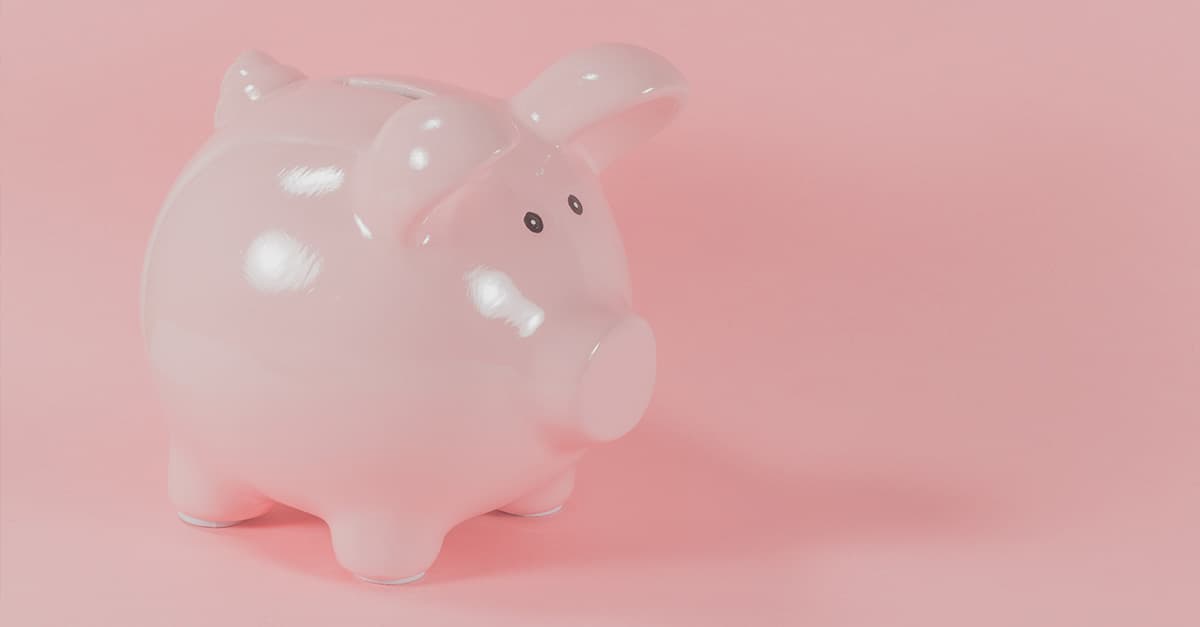 Pink piggy bank set against a pink background